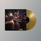 Gold vinyl record partially removed from illustrated album sleeve featuring a bird wearing a crown