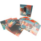 Turquoise and orange marbled vinyl record with printed inner sleeve and photo inserts