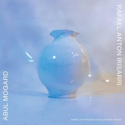 Light blue ceramic vase with a flared rim against a soft blue background