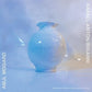 Light blue ceramic vase with a flared rim against a soft blue background