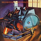 Vinyl LP cover featuring a surreal industrial machine with a large circular component and a figure i