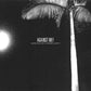 Black and white album cover featuring a palm tree silhouette against a dark sky with a bright moon