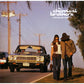 Vinyl LP cover featuring a couple walking on a road with a vintage car in the background