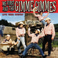 Five band members in plaid shirts and cowboy hats posing around a wooden water tank