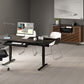 A modern adjustable height standing desk in black with a built-in keyboard tray, styled in a minimalist office setting with a computer, white chairs, and a wooden credenza.