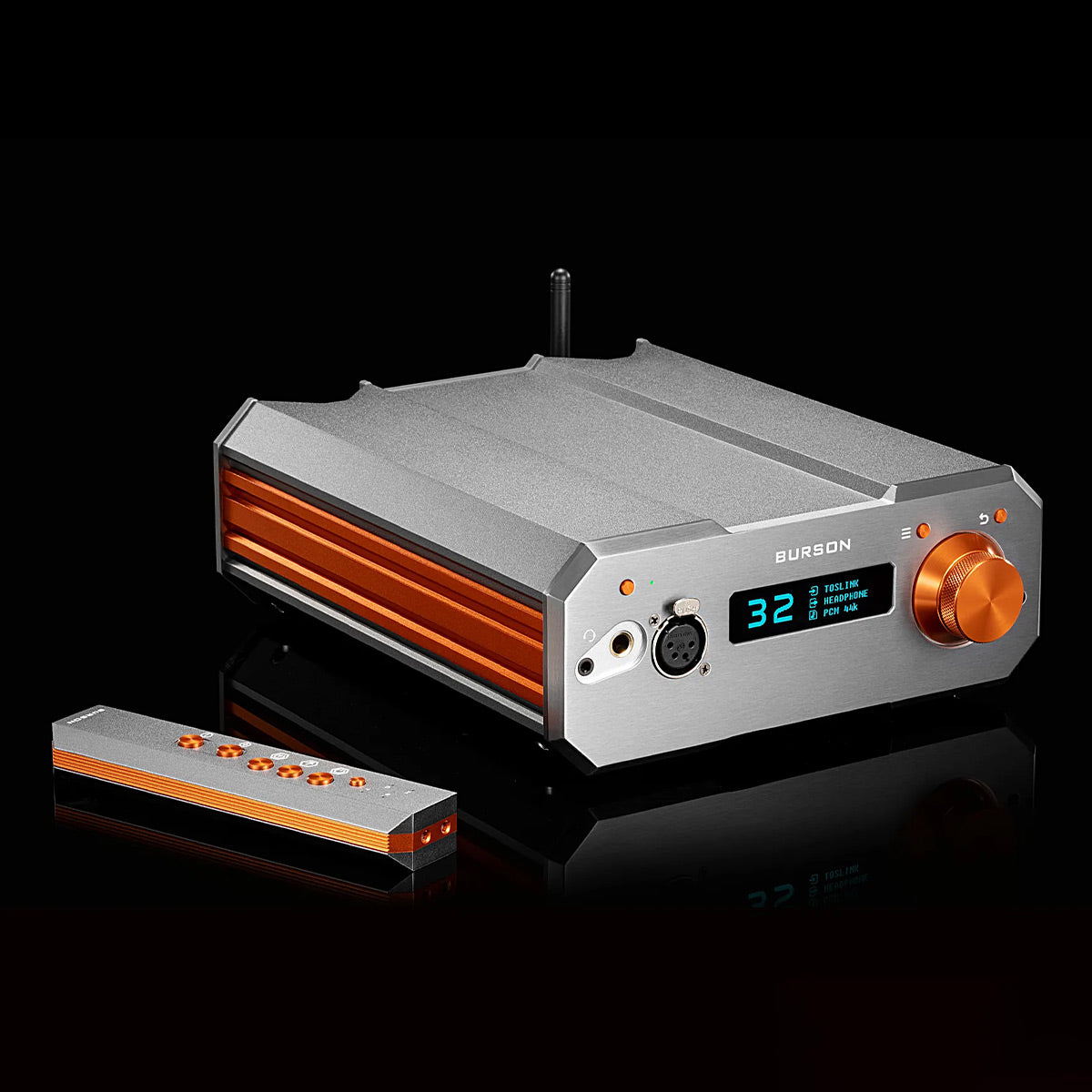 Silver and orange desktop headphone amplifier with digital display and volume knob
