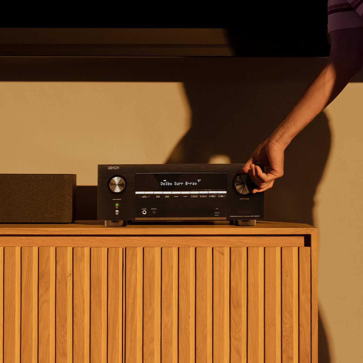Black home theater receiver with dual control knobs and a digital display