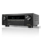 Black brushed metal AV receiver with large volume knob, digital display, and front USB port