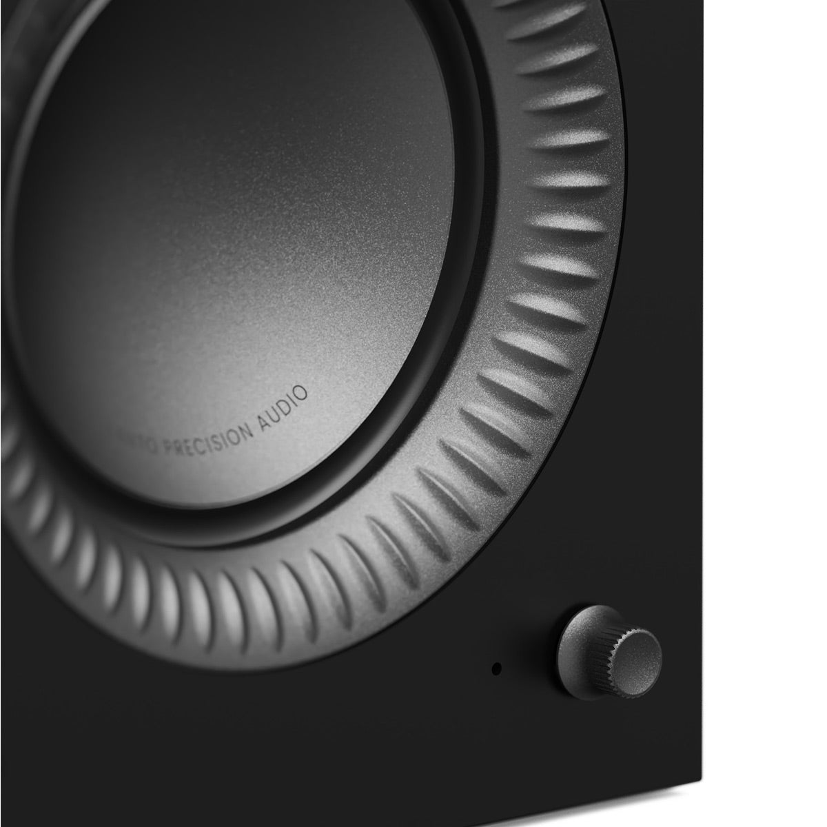 Matte black bookshelf speaker with a large woofer, textured surround, and a front volume knob