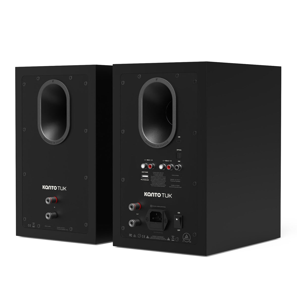 Matte black bookshelf speakers showing rear panels with oval ports and multiple input jacks