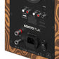 Back panel of a wood-grain speaker with RCA inputs, optical port, and power switch