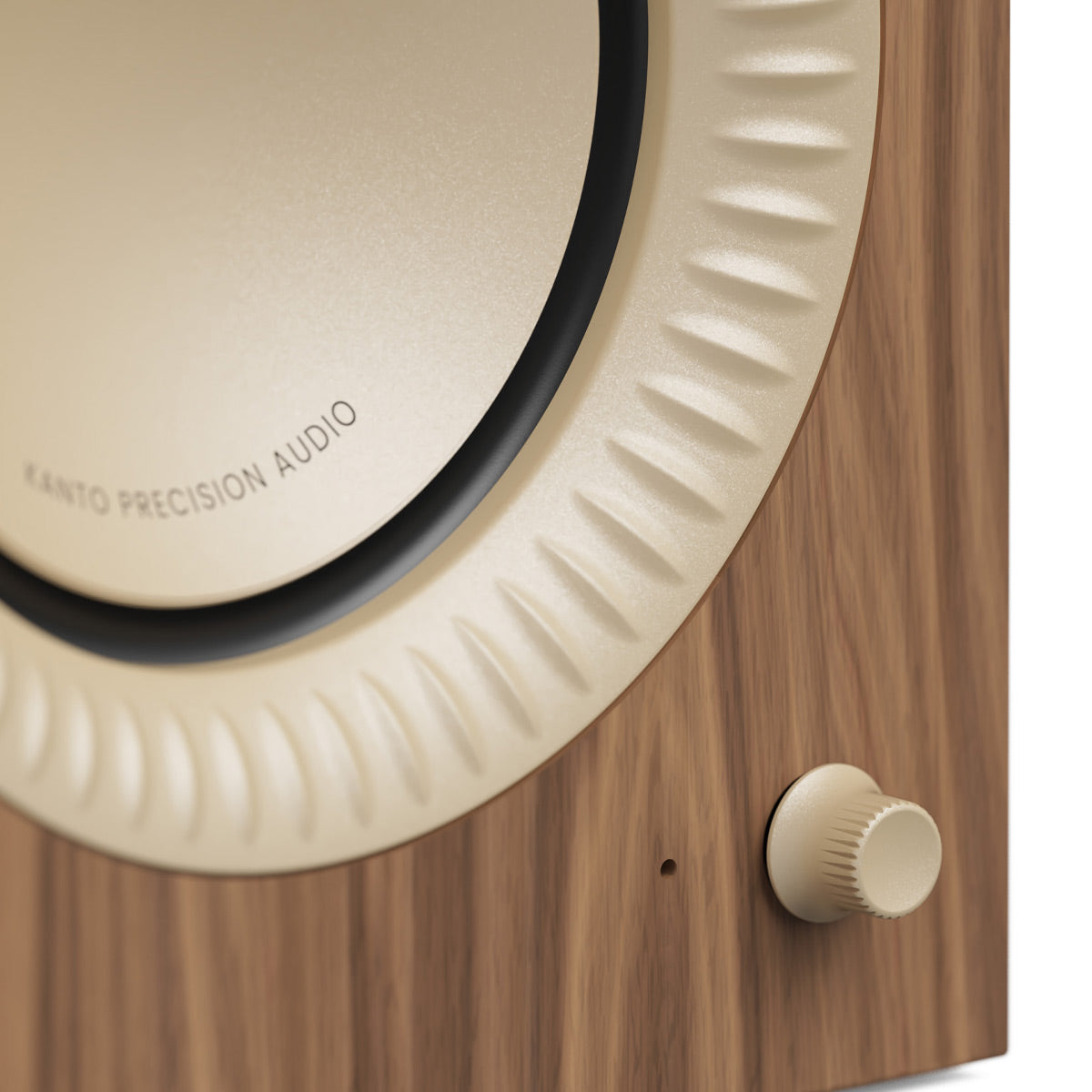Walnut wood speaker cabinet with a cream-colored driver and a textured volume knob