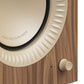 Walnut wood speaker cabinet with a cream-colored driver and a textured volume knob
