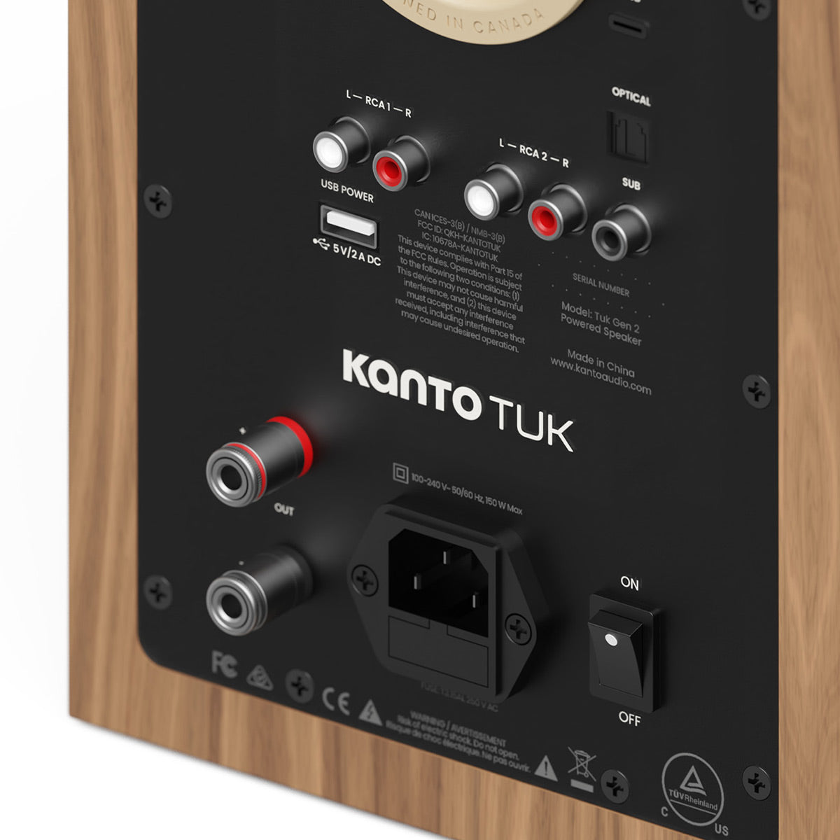 Back panel of a matte walnut bookshelf speaker with RCA, optical, and USB power ports