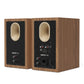 Pair of matte walnut bookshelf speakers with rear-facing ports and multiple input connections