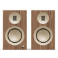 Pair of matte walnut bookshelf speakers with cream-colored drivers and a front volume knob