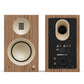 Matte walnut bookshelf speaker with cream-colored drivers and rear connectivity panel