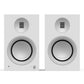 Matte white bookshelf speakers with silver drivers and a front volume knob