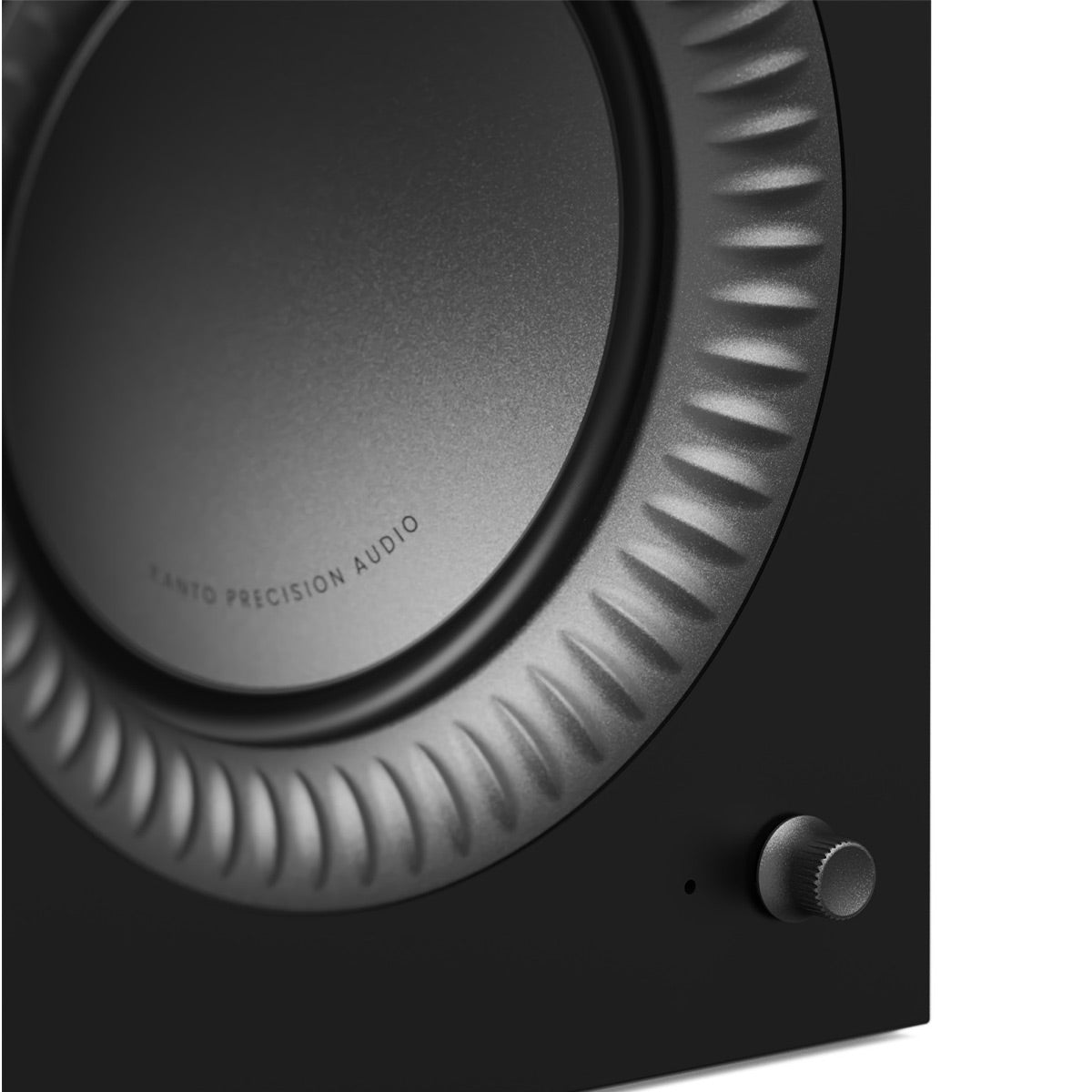 Matte black speaker cabinet with a large circular driver and a textured volume knob