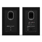Matte black bookshelf speakers with rear bass ports and multiple input connections