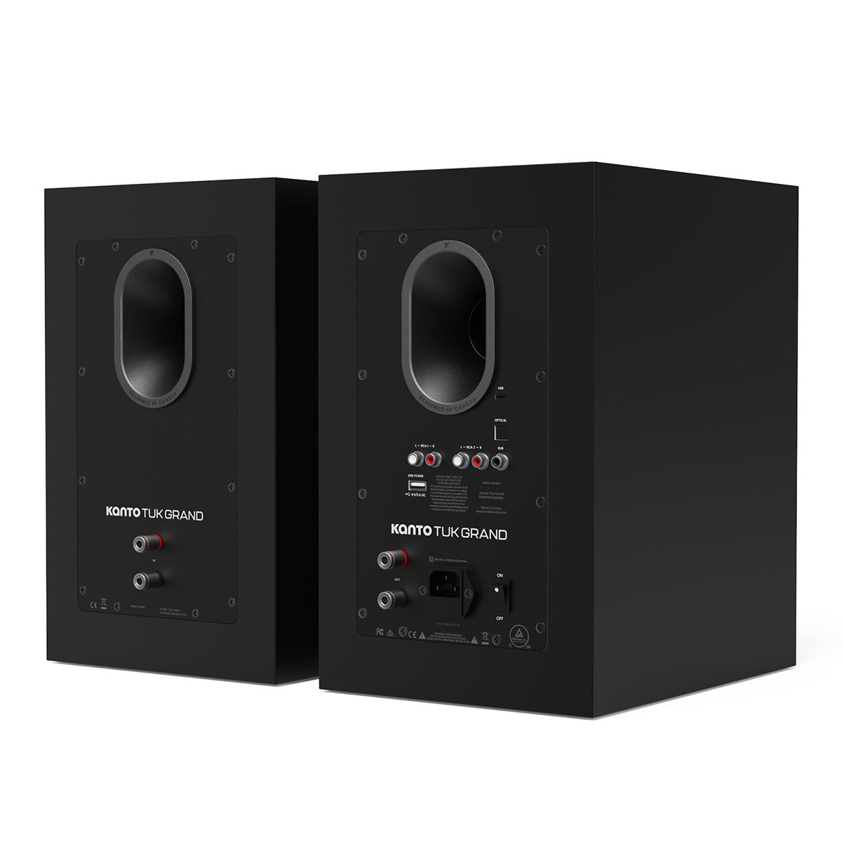 Matte black bookshelf speakers with rear-facing ports and multiple input connections