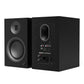 Matte black bookshelf speaker with a front-facing woofer and rear panel featuring RCA inputs and a p