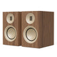 Pair of bookshelf speakers with matte walnut wood veneer cabinets and cream-colored drivers