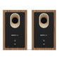 Pair of matte walnut bookshelf speakers with black rear panels and oval bass ports