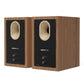 Pair of matte walnut bookshelf speakers with black rear panels and oval ports