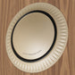 Gold-tone speaker driver with a textured surround and black rubber trim